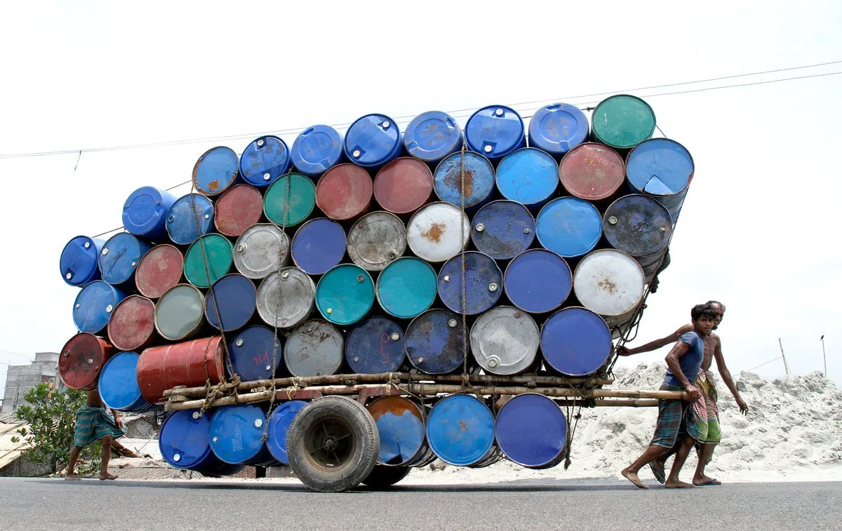 two people pull a cart of used containers in dhaka bangladesh