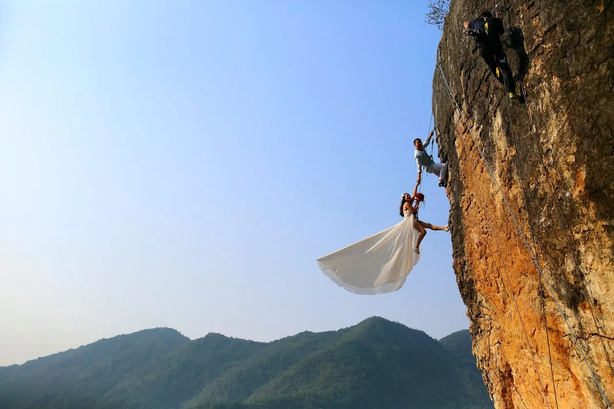 zheng feng an amateur climber takes wedding pictures with his bride on a cliff in jinhua china