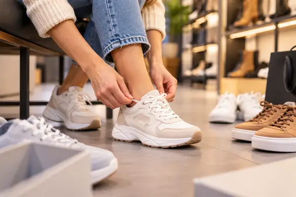 Tying Sneakers in a Cozy Shoe Boutique