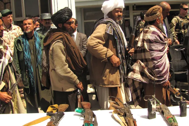 former taliban fighters return arms