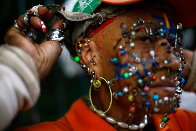 a street cleaner and fan of the brazilian national world cup soccer team shows the myriad of piercings on her face on a street in belo horizonte july 3 2014