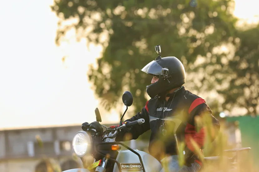 canva motorcyclist sitting on gray motorcycle outdoors