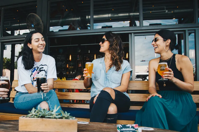 canva three women sitting on bench 1