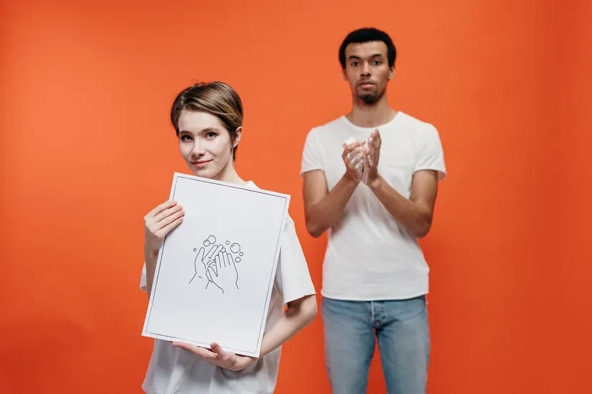 canva woman holding a poster on proper hand washing