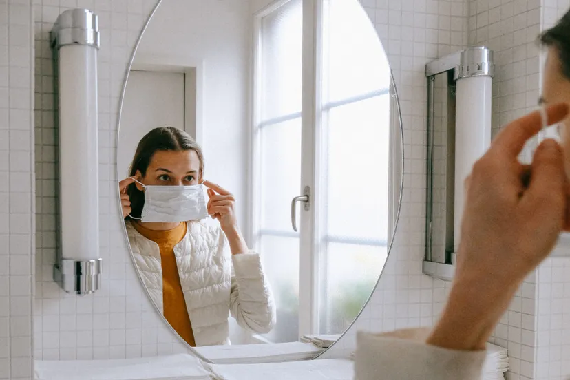 person putting on face mask 3943904 e1585648121937