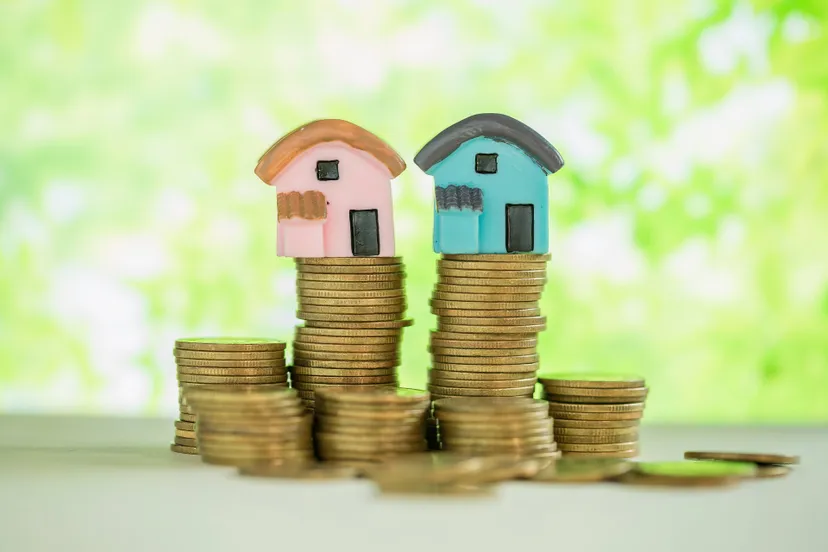 mini-house-stack-coins-with-green-blur