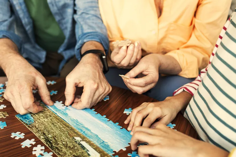 close-up-people-doing-puzzle-together