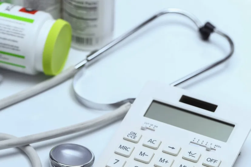 calculator-stethoscope-medicine-bottles-white-background
