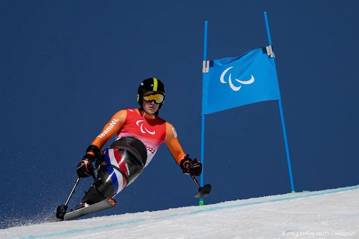 zitskier de langen draagt vlag bij sluiting paralympische spelen