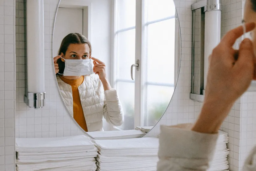 person putting on face mask 3943904 e1585217904387