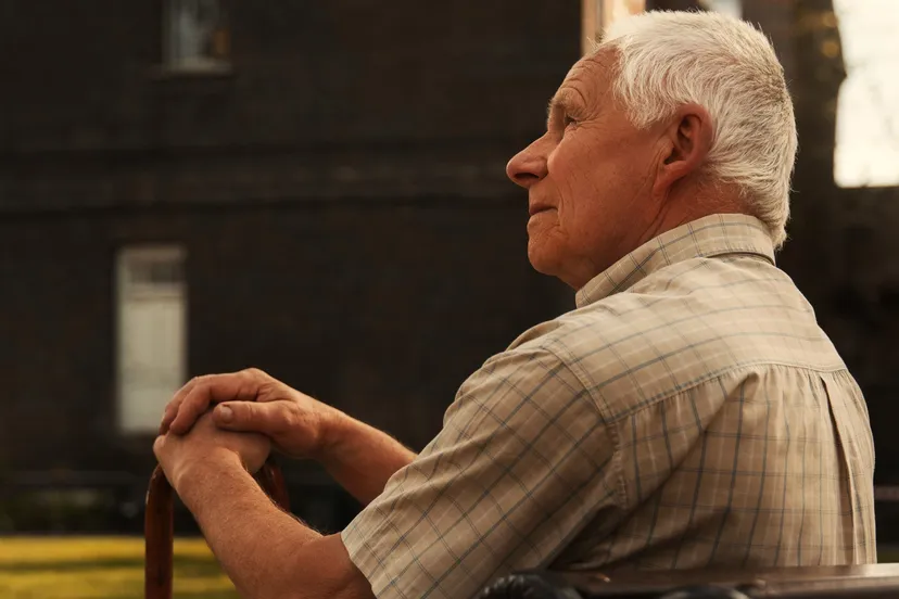 side view old man sitting bench