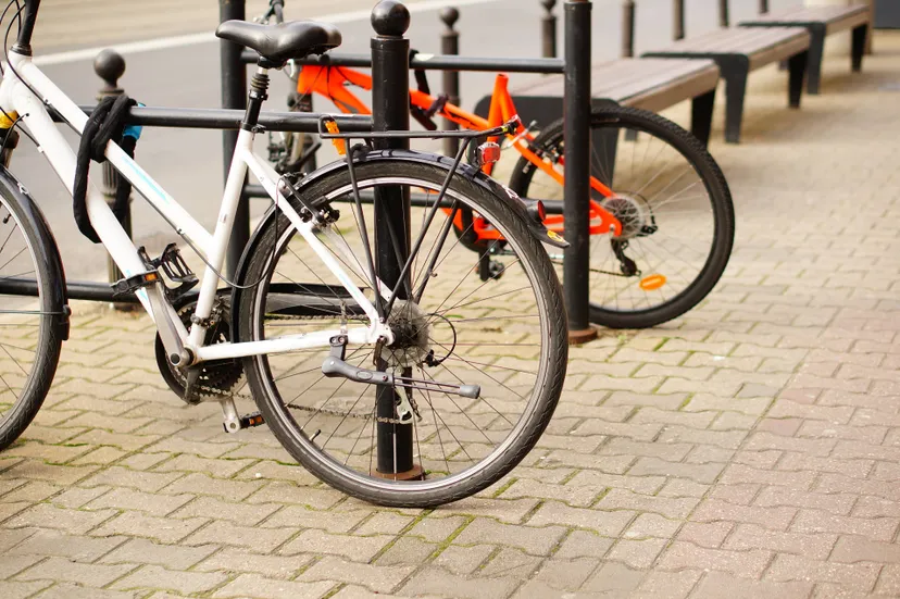 low-angle-closeup-shot-two-bicycles-parked-sidewalk