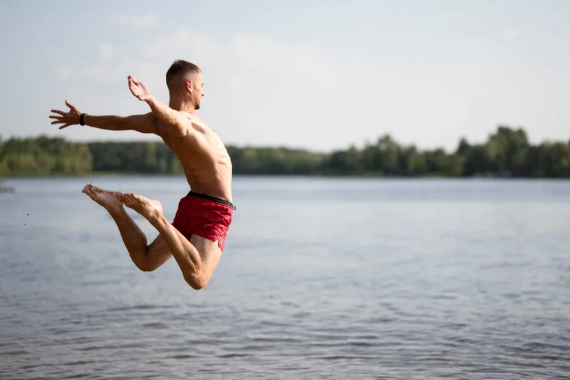 man-jumping-lake