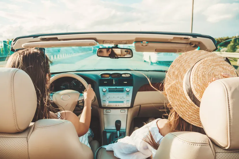 portrait-two-young-beautiful-smiling-hipster-female-convertible-car