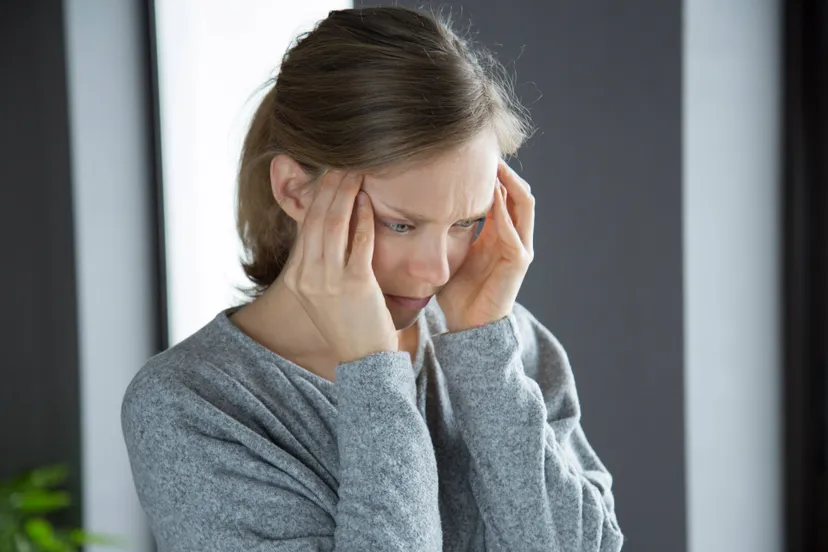 sick-woman-home-massaging-temples-feeling-strong-headache