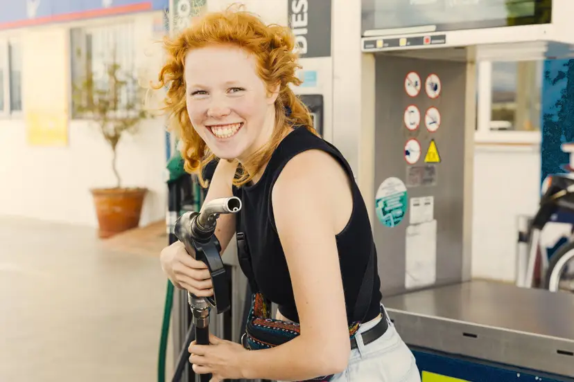 woman-having-fun-with-filling-gun-smiling-looking-camera