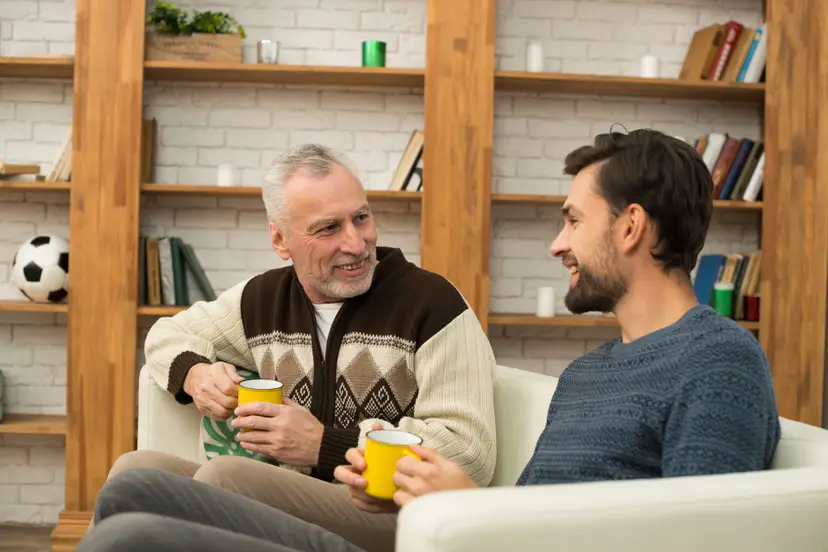 young-smiling-guy-aged-man-with-cups-settee