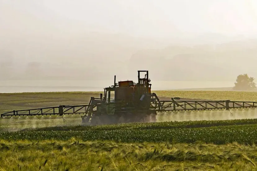 boer besproeit gewas