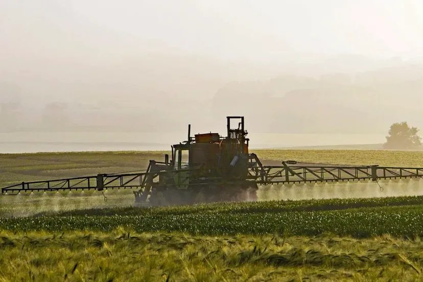 boer besproeit gewas