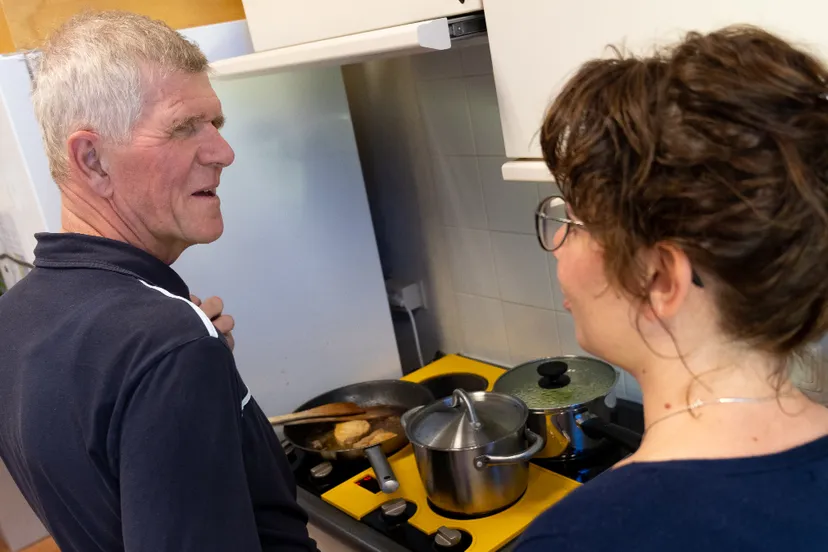 slechtziende man en therapeut koken op aangepaste kookplaat