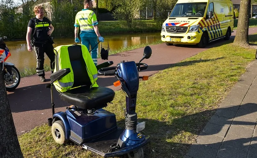 man in scootmobiel te water