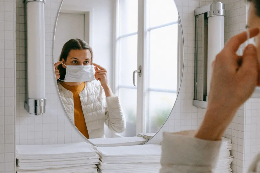 person putting on face mask 3943904 e1585648429322