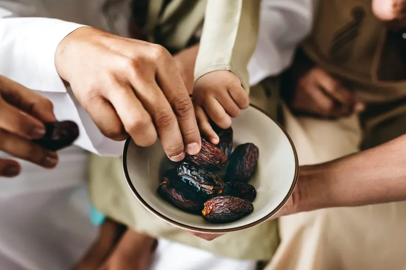people sharing some dried dates