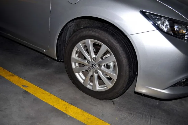 metallic silver car with alloy wheels on parking 725x482