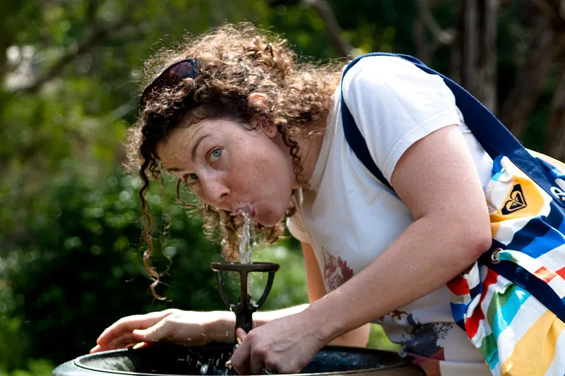 800px woman drinking from a water fountain the rohit wikimedia