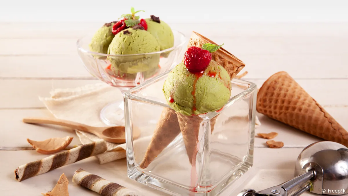 green ice cream glass sprinkled with lasagne chocolate wooden table