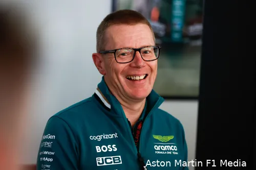Aston Martin F1 team principal and CEO Andy Cowell smiling at the camera with a blurred background behind.