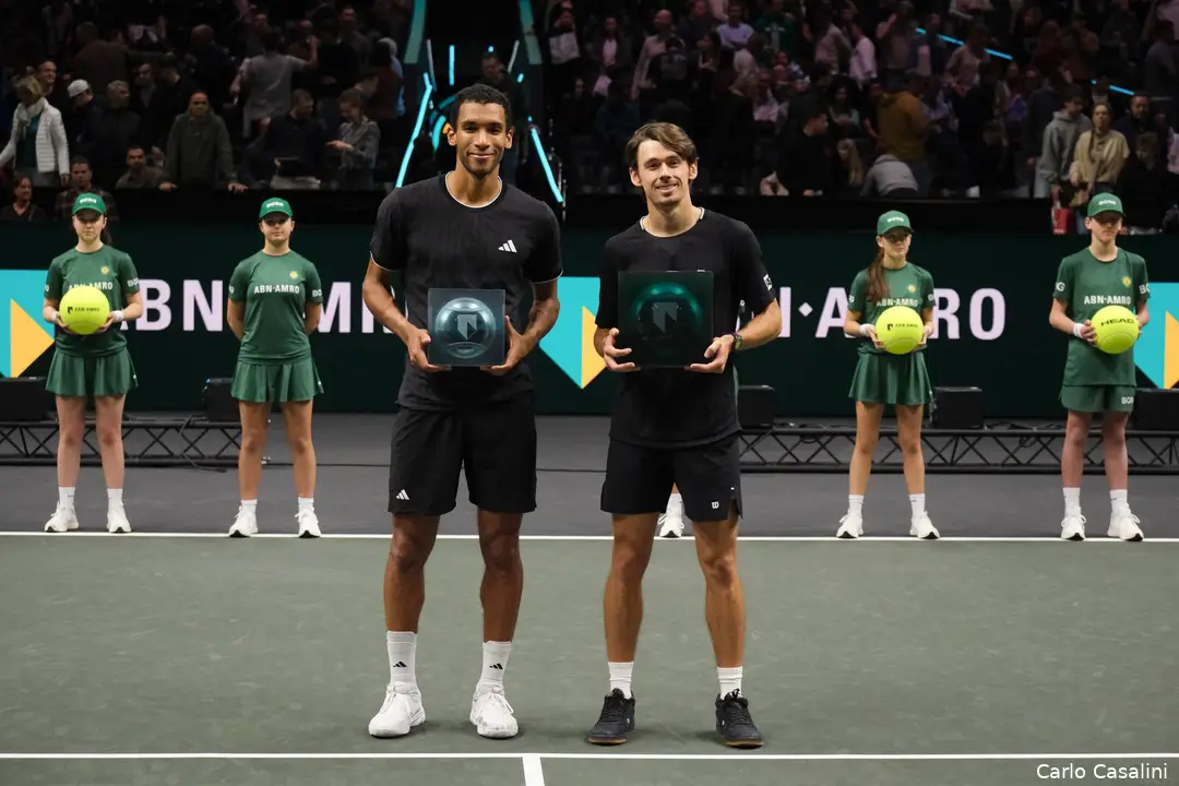 Felix Auger-Aliassime and Alex de Minaur holding their trophies at the ABN AMRO Rotterdam Open trophy presentation ceremony.