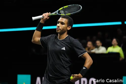 Felix Auger-Aliassime lifts racquet.