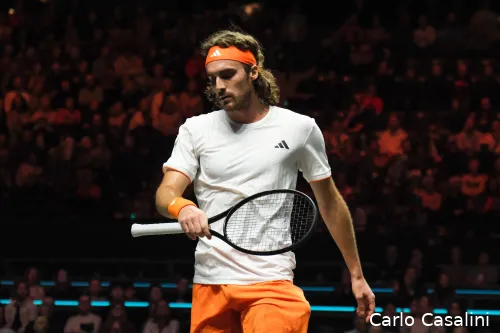 Stefanos Tsitsipas lifts racquet.