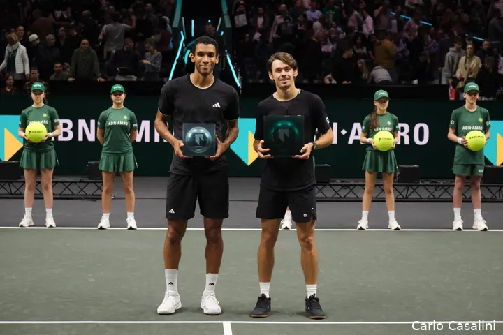 Felix Auger-Aliassime and Alex de Minaur holding their trophies at the ABN AMRO Rotterdam Open trophy presentation ceremony.