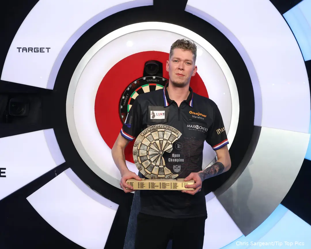 Jimmy van Schie holds Lakeside trophy in his hands.