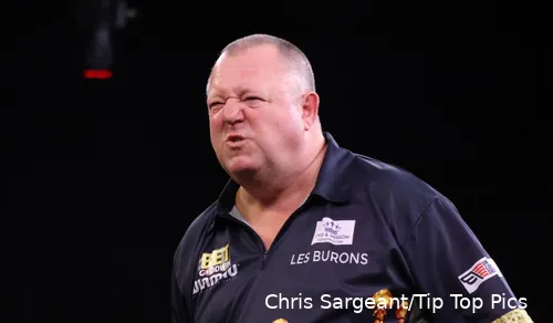 Mervyn King snarls on stage.