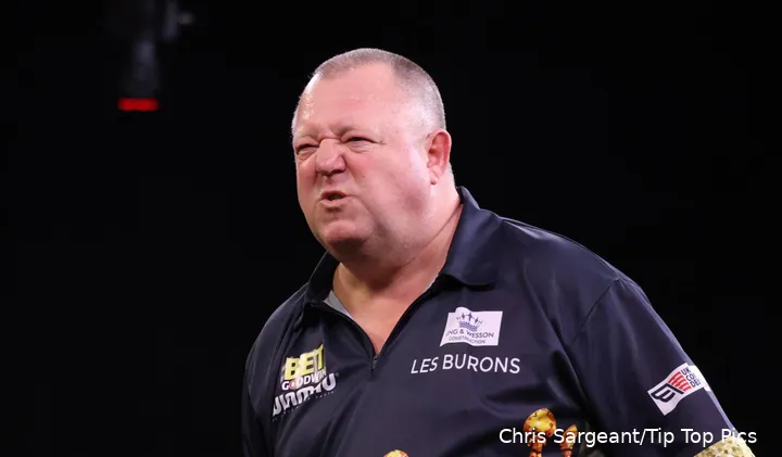 Mervyn King snarls on stage.