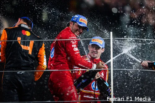 Lando Norris, Carlos Sainz, and Charles Leclerc spraying champagne in celebration on the podium after the 2024 Abu Dhabi Grand Prix.
