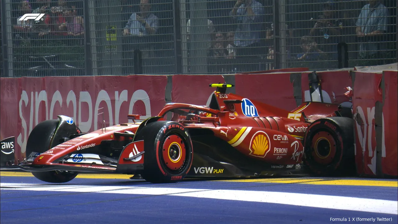 Ferrari car driven by Carlos Sainz crashes into the Tecpro barrier near the main straight, with severe damage to the rear. Fans are visible in the background, watching the aftermath.