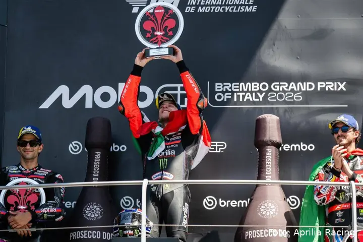 Marco Bezzecchi raises the winner’s trophy on the MotoGP podium at Mugello