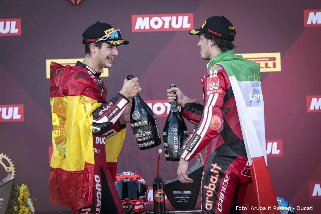 Iker Lecuona and Nicolò Bulega celebrate on the Superbike podium with bottles of Prosecco DOC