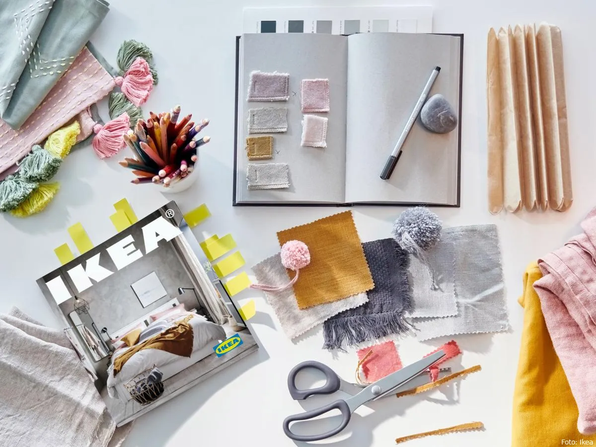 bookmarked ikea catalog on a desk beside a textile swatches c2bf3b15107412fe4e136907d8710c8e 1 1