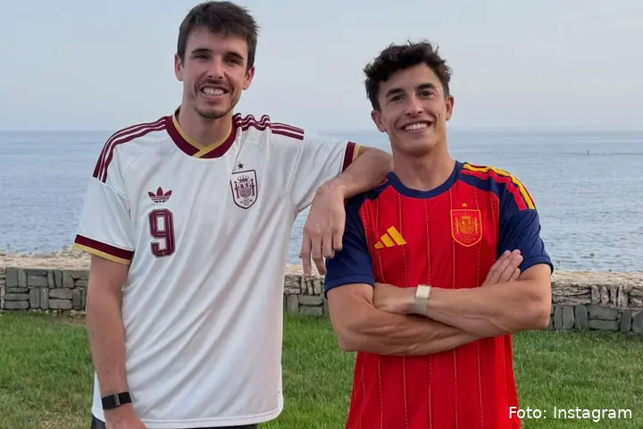 Alex Marquez and Marc Marquez posing for a photo wearing Spain’s national soccer team jerseys