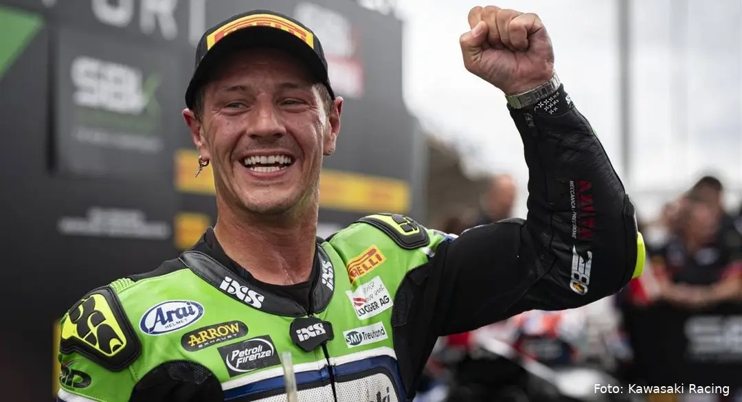 Dominique Aegerter smiles and celebrates wearing the green and black leathers of the Kawasaki WorldSSP team