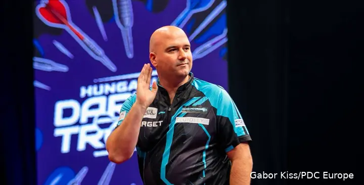 Rob Cross putting his hand to his ear