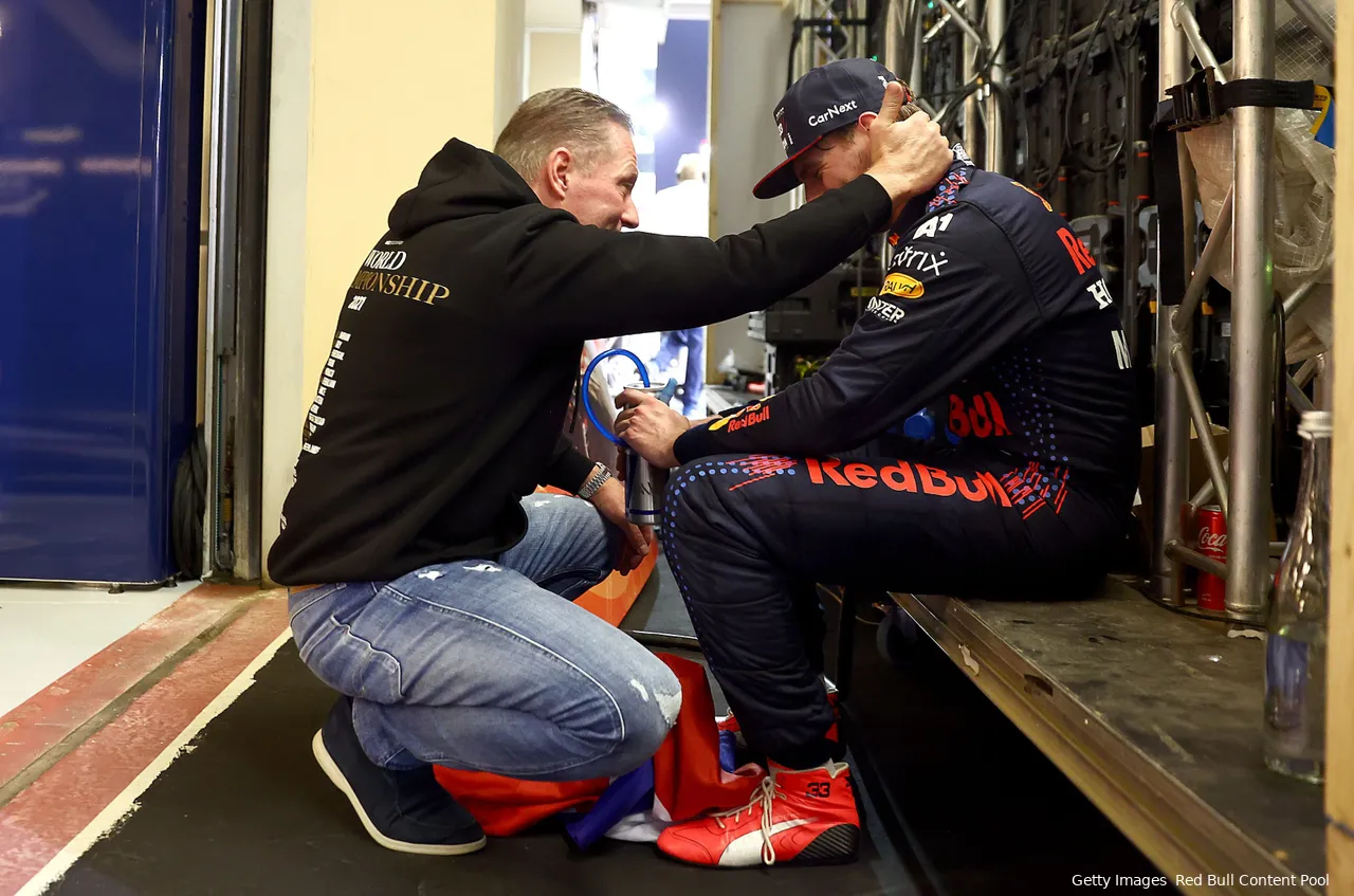 Jos Verstappen and Max Verstappen sharing an emotional moment backstage after winning the 2021 F1 Championship in Abu Dhabi.