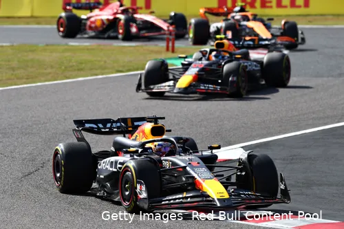 Max Verstappen, followed by Sergio Perez, followed by Lando Norris, followed by Carlos Sainz around the last two turns at Suzuka Circuit