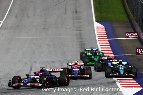 Daniel Ricciardo turning into the first corner at Red Bull Ring after the Grand Prix start, followed by Yuki Tsunoda, Fernando Alonso, Alex Albon, Valtteri Bottas, and Lance Stroll.
