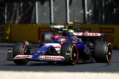 Yuki Tsunoda turning his VCARB into one of the corners at the Melbourne circuit, closely followed by Lewis Hamilton in his Mercedes,